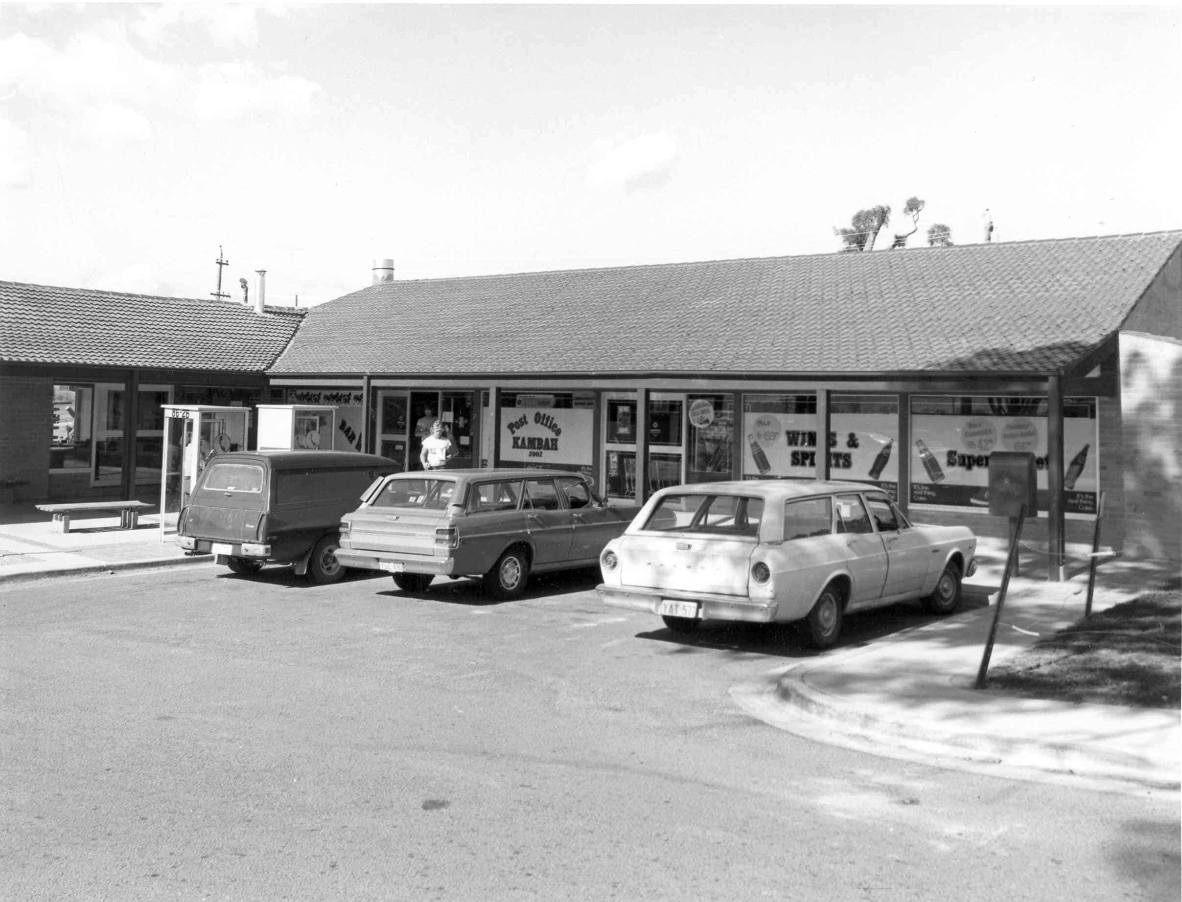 Photo of 3 cars parked outside shops. Photo taken in the mid 70s, and part of the ACT Archives collection.